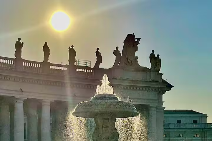 Sunrise over St Peter’s Square fountain and statues, captured during a VIP early morning St Peter’s Basilica dome tour
