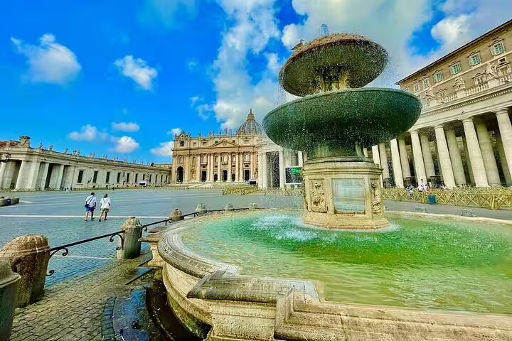 Majestic fountain in St Peter's Square with St Peter's Basilica in the background on a VIP early morning dome climb tour