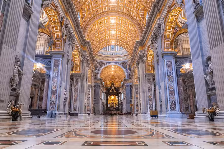 Interior of St. Peter's Basilica showcasing ornate architecture and grandeur, perfect for Rome's dome climb and underground tour.
