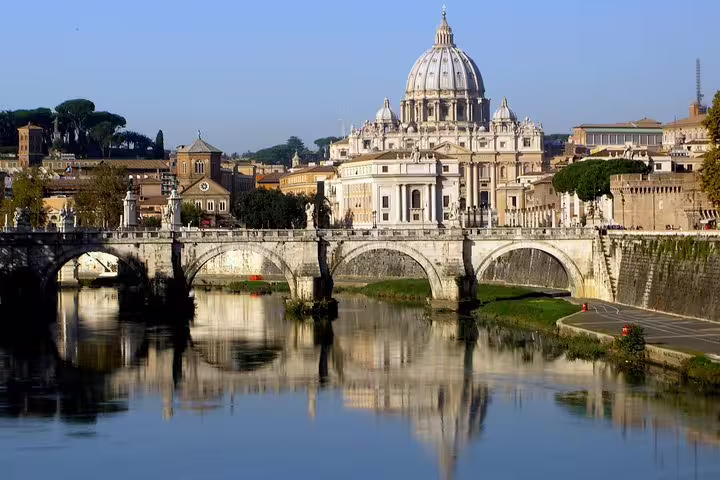 Panoramic view of St Peter’s Basilica and the Tiber River bridge on a sunny Rome in one day private tour with hotel pickup