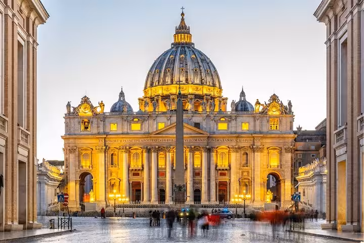 St. Peter's Basilica illuminated at dusk, a key highlight of the Colosseum and Vatican Museums guided tour.