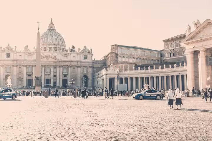 Discover the iconic St. Peter's Basilica in Vatican City, with bustling tourists and historic architecture in the square.