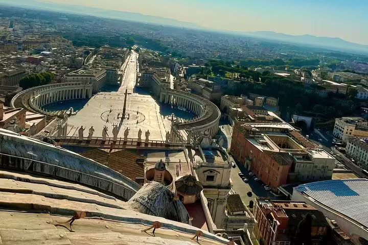 Aerial view from St Peter's Basilica dome overlooking St Peter's Square and Rome on a VIP early access tour