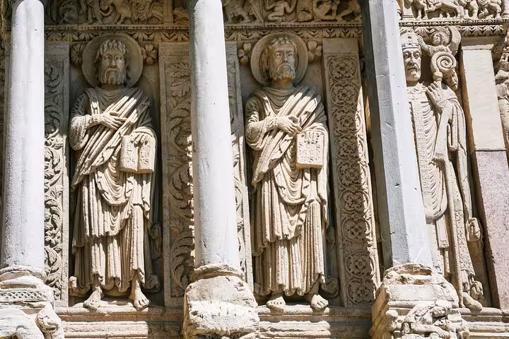 Intricate stone carvings on the façade of St. Trophime Church in Arles, highlighting Romanesque artistry.