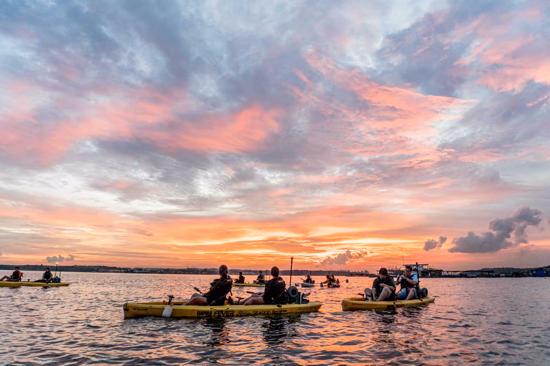 Kayakers enjoy vibrant sunset skies during the Starry Night kayak fishing tour at Pulau Ubin.