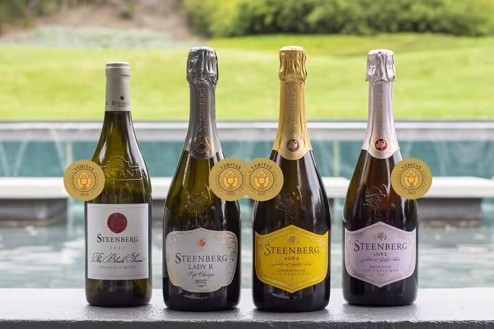 Award-winning Steenberg sparkling wines and Sauvignon Blanc showcased with gold medals in Cape Town vineyard.