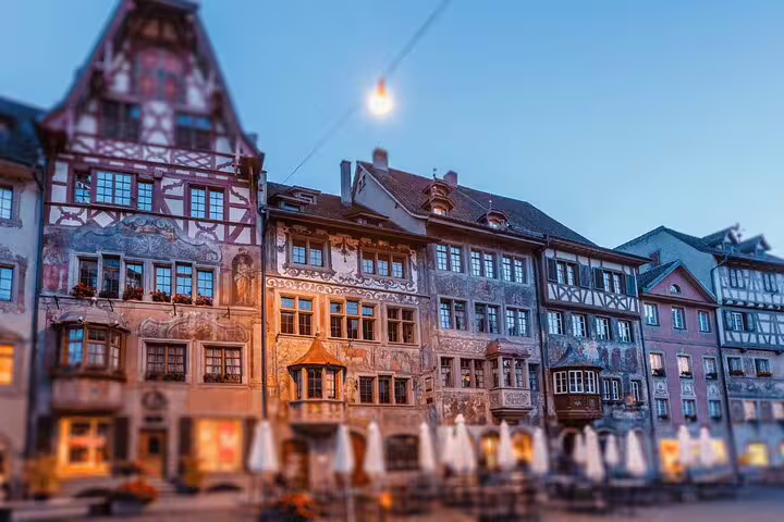 Charming historic buildings in Stein am Rhein at dusk, featuring intricate frescoes and medieval architecture.