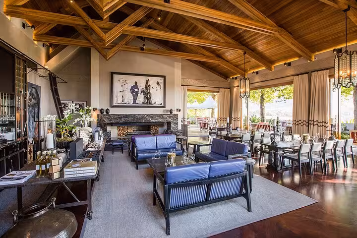 Luxurious Stellenbosch winery interior with wooden beams, offering an inviting setting for wine tasting tours.