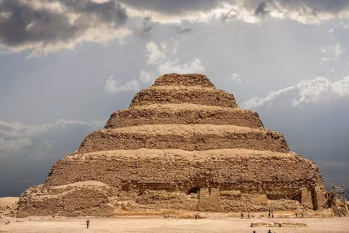 Step Pyramid of Djoser at Saqqara under dramatic clouds, key stop on Giza Pyramids Saqqara Memphis tour