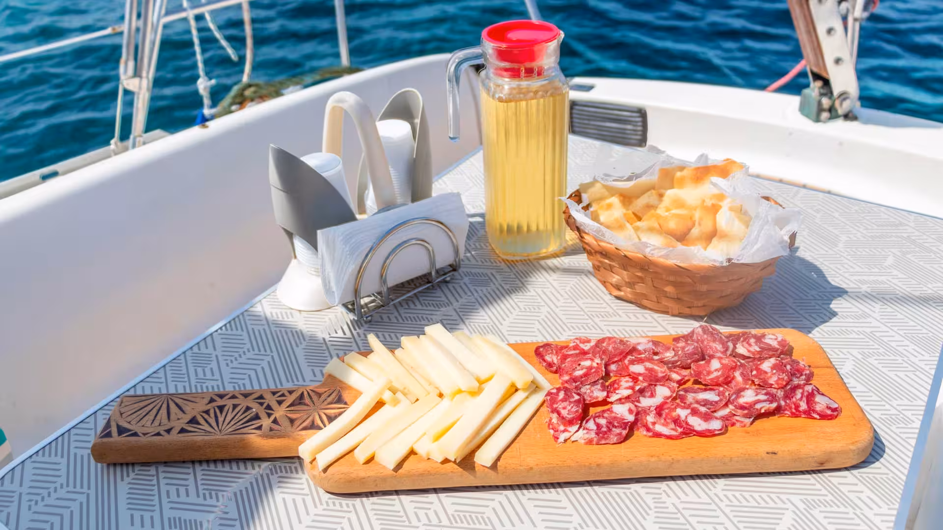 Delightful charcuterie board with cheese and salami on a sailboat during Stintino tour to Asinara with lunch.