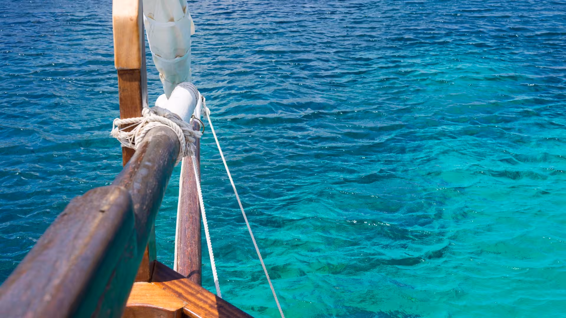 Turquoise waters of the Mediterranean Sea as seen from a sailboat near Asinara Island, perfect for a sailing excursion.