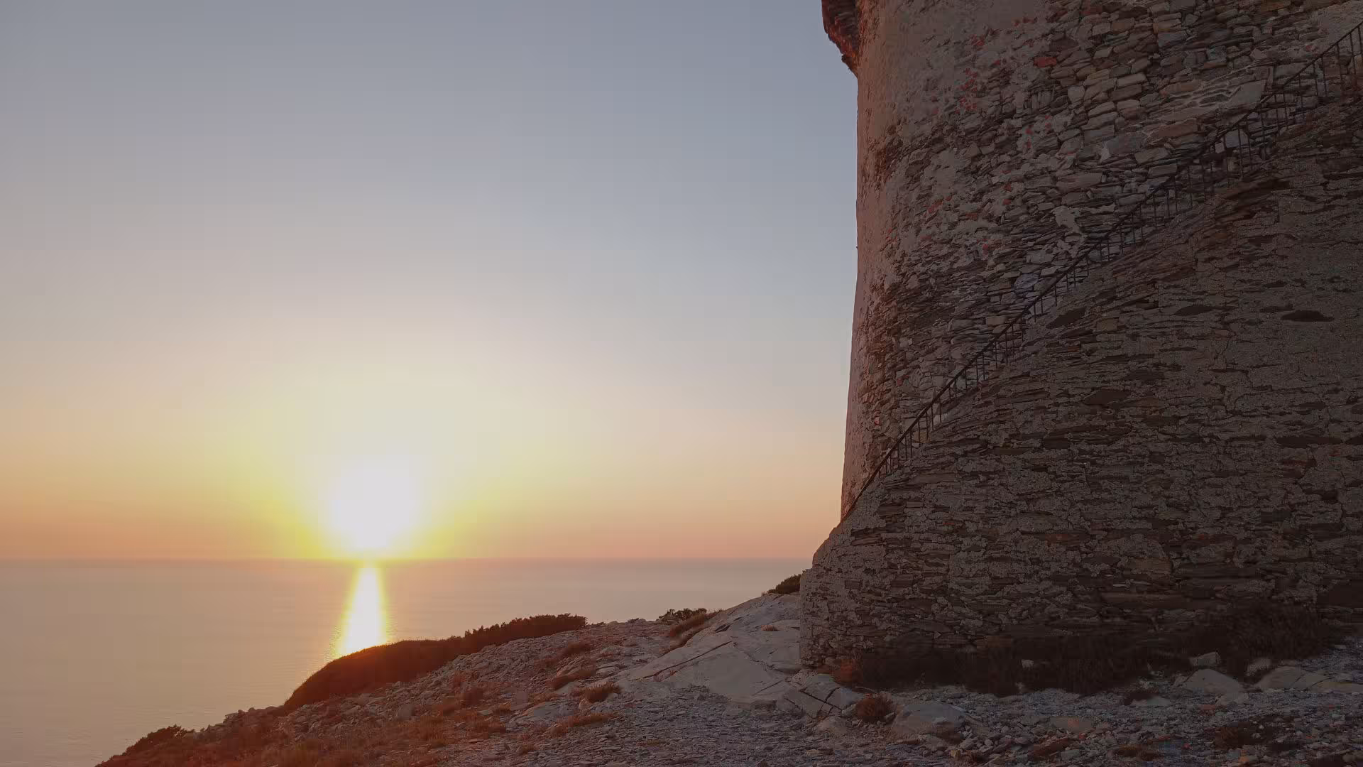 Stunning sunset at Capo Falcone with ancient tower, perfect for Stintino hiking and tasting tour.