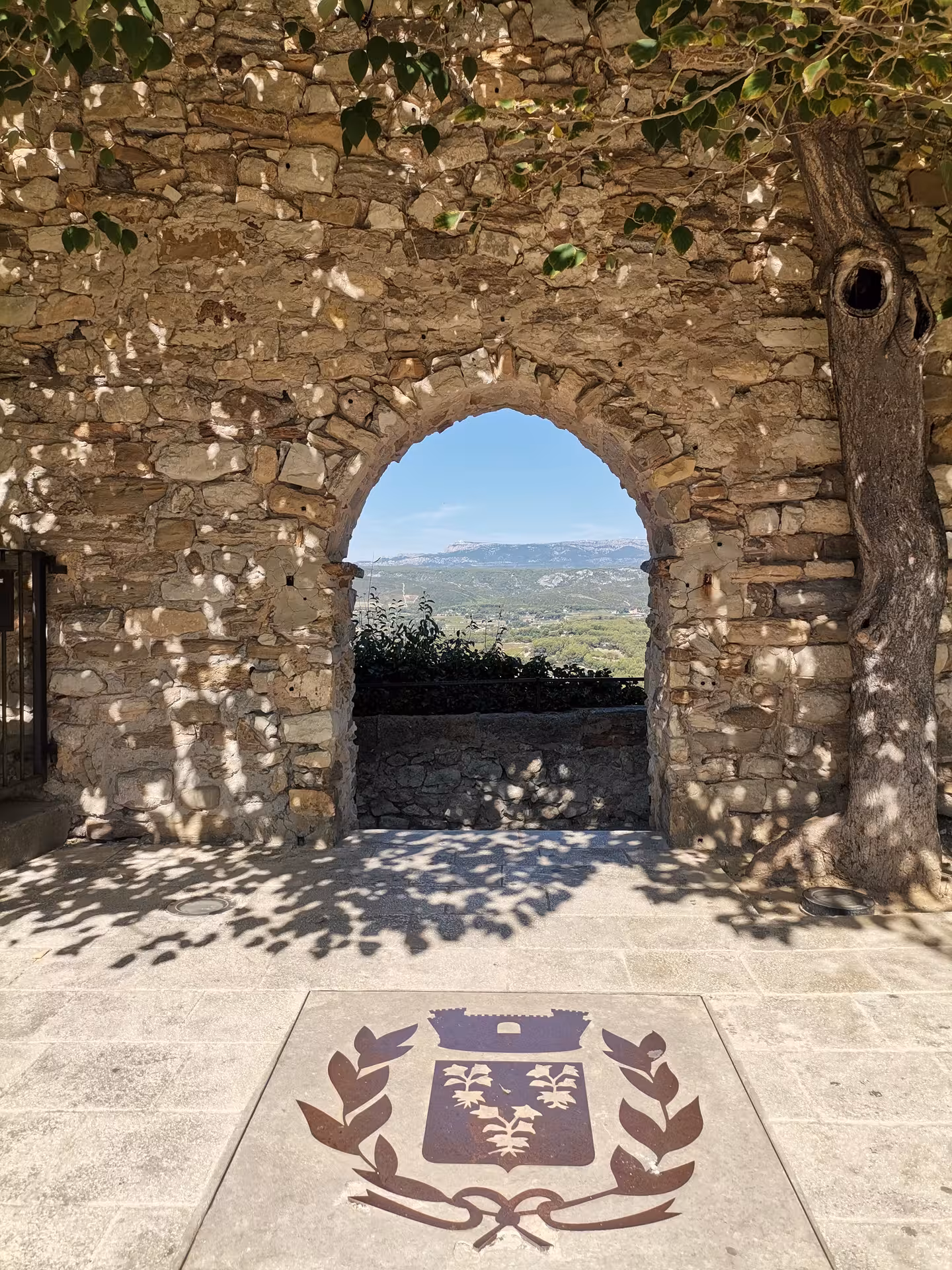 Stone arch viewpoint framing Provence landscape near Sainte-Victoire on Coteaux d'Aix-en-Provence tour