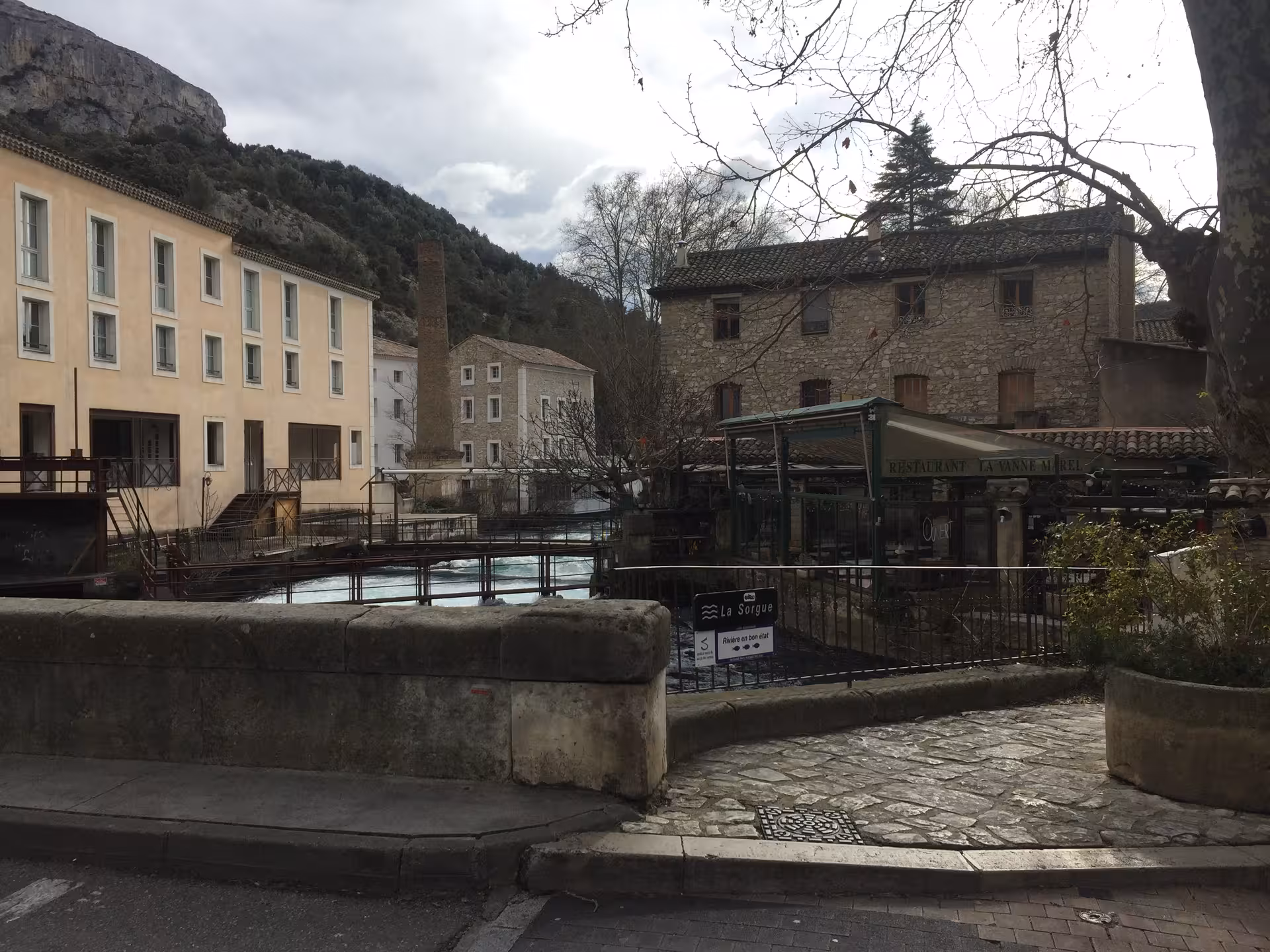 Stone bridge over the Sorgue River in L'Isle-sur-la-Sorgue, Provence village tour with canals and old mills