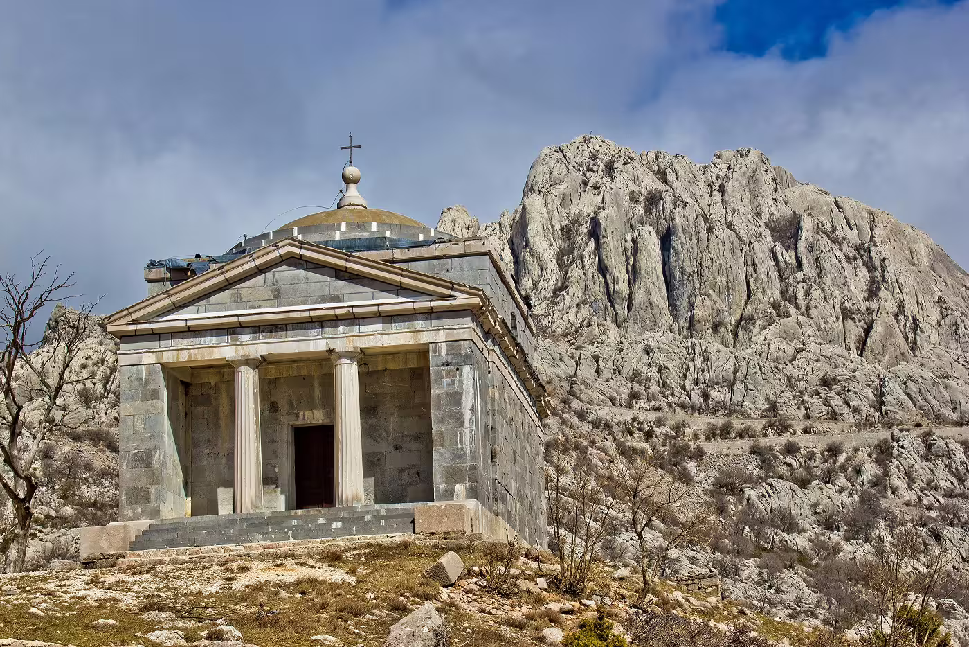 Stone chapel beneath rugged Velebit peaks on a Croatia UNESCO Heritage self-drive road trip route