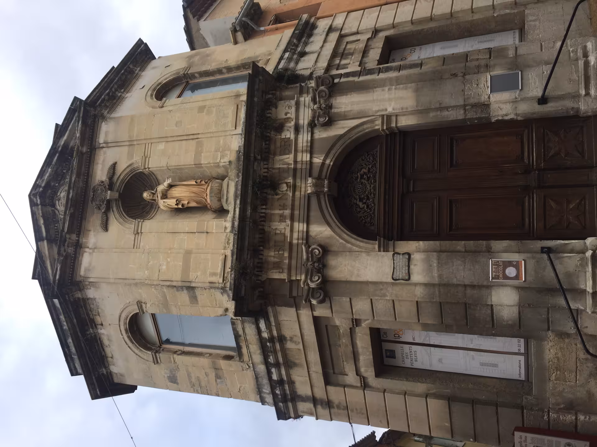 Stone church facade in L'Isle-sur-la-Sorgue, Provence, a highlight of the Gordes and Roussillon village tour