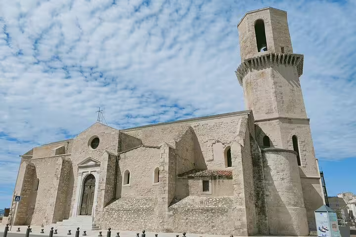 Stone church in Marseille on the e-scavenger hunt route, a self-guided walking tour landmark under blue skies