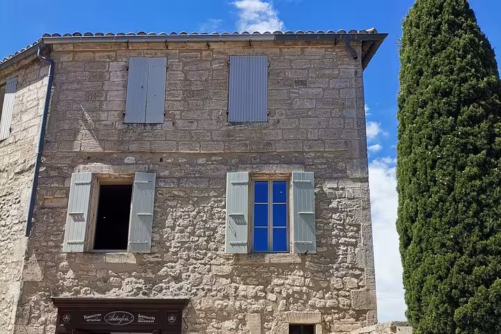 Stone house with pastel shutters in Les Baux-de-Provence, scenic stop on Saint Rémy culture tour