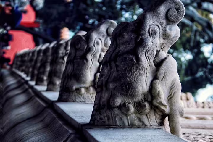 Stone lion statues line an ancient pathway, highlighting China's rich cultural heritage on the Yangtze River tour.