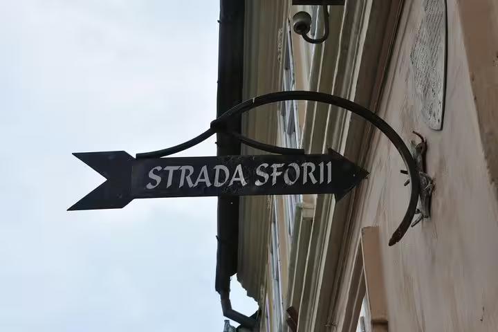 Black iron arrow street sign for Strada Sforii in Brasov Old Town
