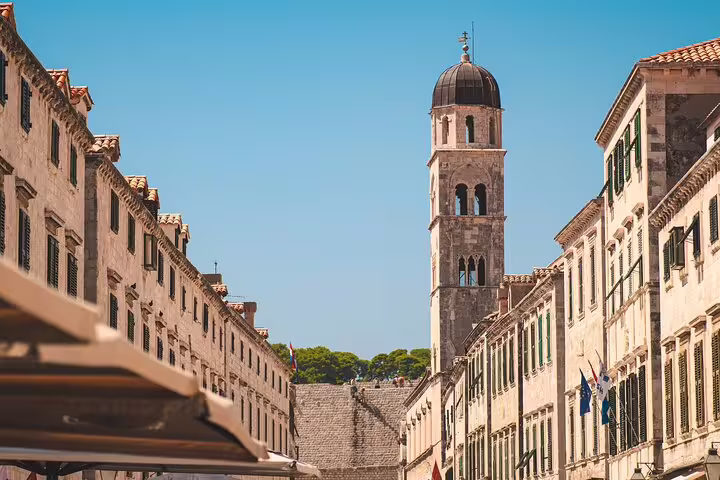 Stradun street view with Dubrovnik Cathedral bell tower on a private Dubrovnik Old Town walking tour