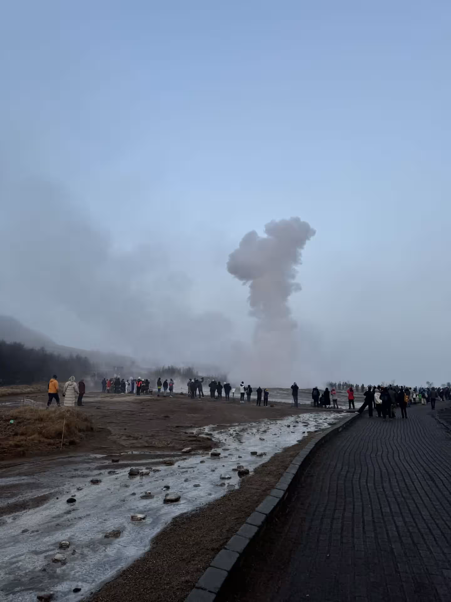 Tourists watch Strokkur geyser erupting at Geysir area on Grand Golden Circle tour from Reykjavik, Iceland