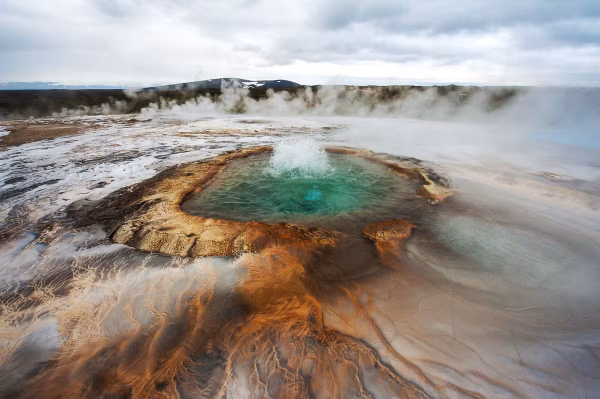 Strokkur geyser geothermal pool erupting in Haukadalur, must-see Golden Circle stop on Iceland day tour