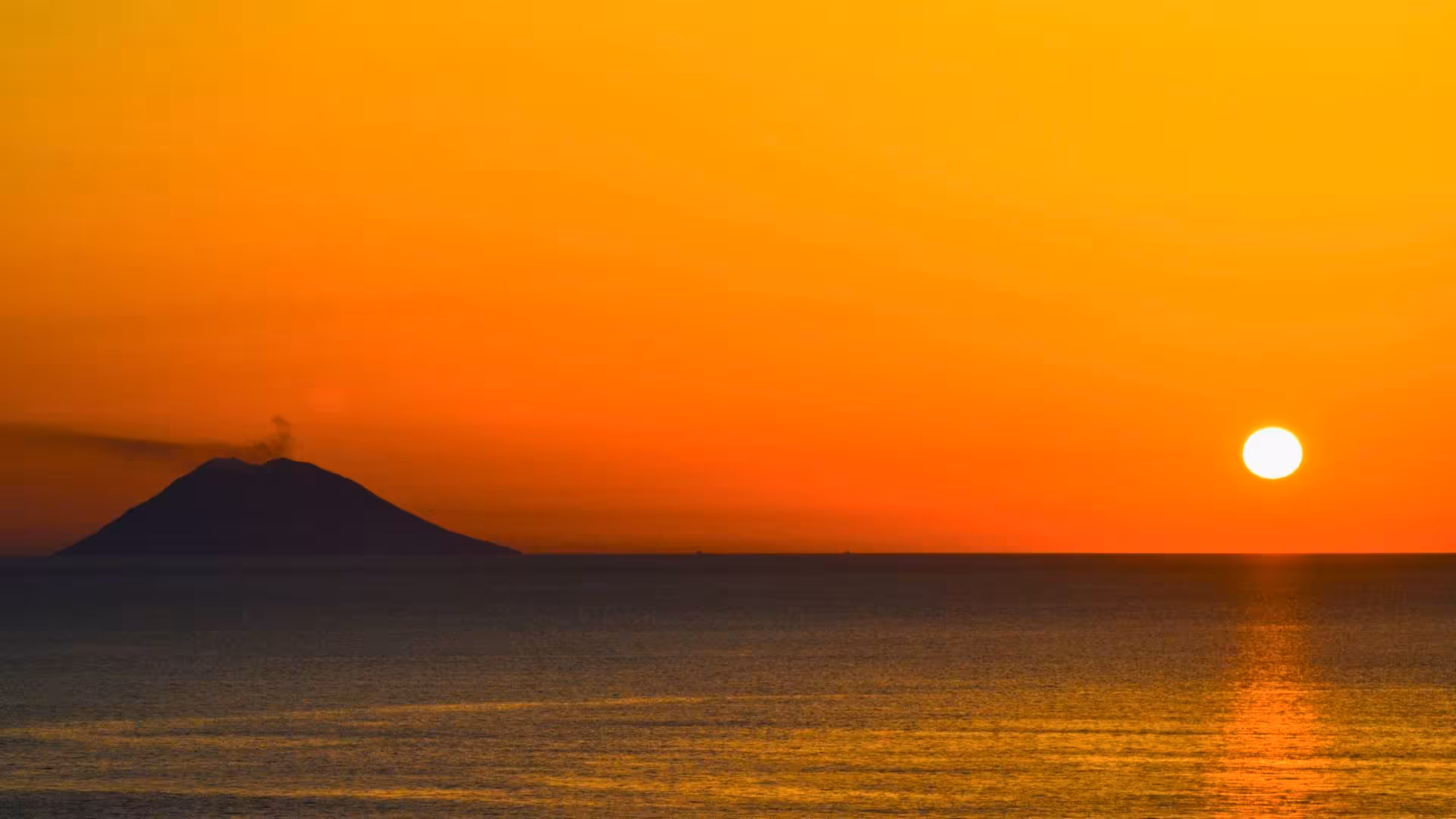Breathtaking sunset over Stromboli volcano viewed from the Aeolian Islands mini cruise tour.