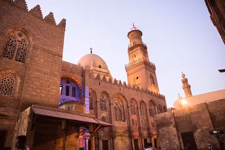Sunset view of Sultan Hassan Mosque in Islamic Cairo, a stop on private guided Cairo Citadel and Old Cairo tour