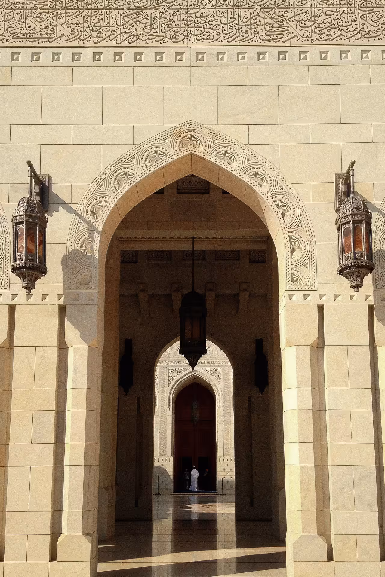 Ornate archway and lanterns at Sultan Qaboos Grand Mosque entrance, captured on a private half day Muscat city sightseeing