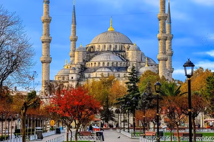 historic mosque framed by warm seasonal colors. Sultanahmet area mosque with minarets in Istanbul