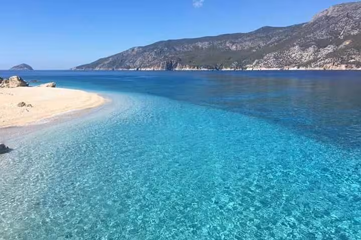 Panoramic Suluada Island beach with vivid turquoise sea, Antalya boat trip with meal and swimming breaks