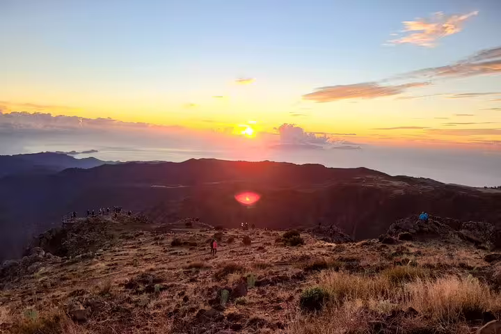 Spectacular sunrise at Areeiro Peak with vibrant skies and panoramic views, perfect for an unforgettable hiking adventure in Madeira.