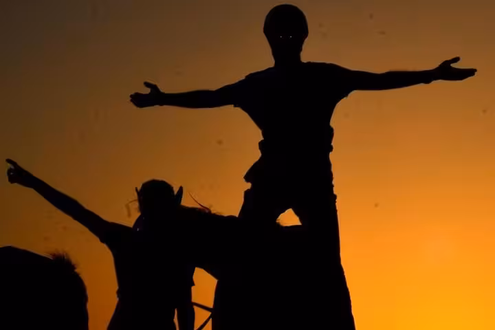Rider with arms wide at sunrise during Marsa Alam horse riding tour, desert and beach adventure at dawn