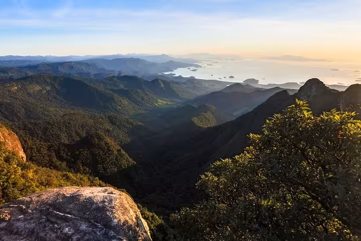 Golden sunrise over Pedra da Macela with dramatic peaks and vibrant skies, ideal for capturing Paraty's natural beauty.