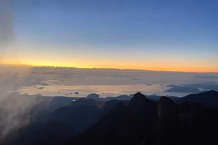 Breathtaking sunrise view from Pedra da Macela, Paraty, showcasing vibrant skies and expansive landscapes.