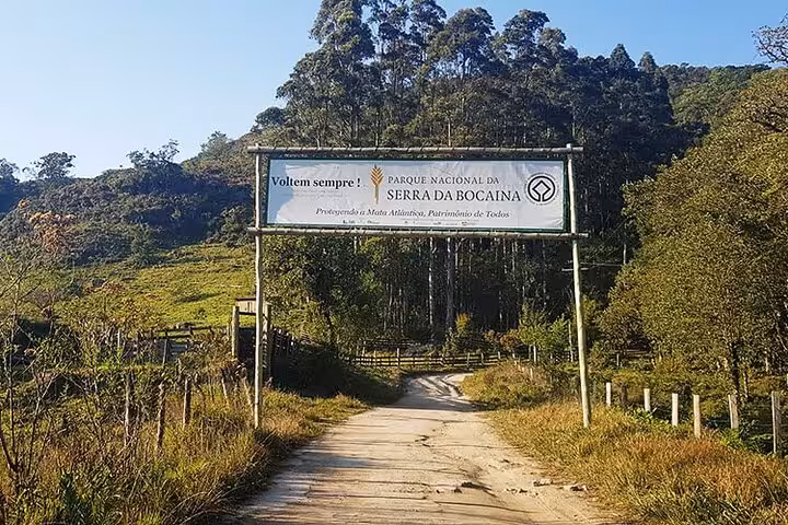 Entrance to Parque Nacional da Serra da Bocaina, showcasing lush greenery and inviting pathways near Pedra da Macela.