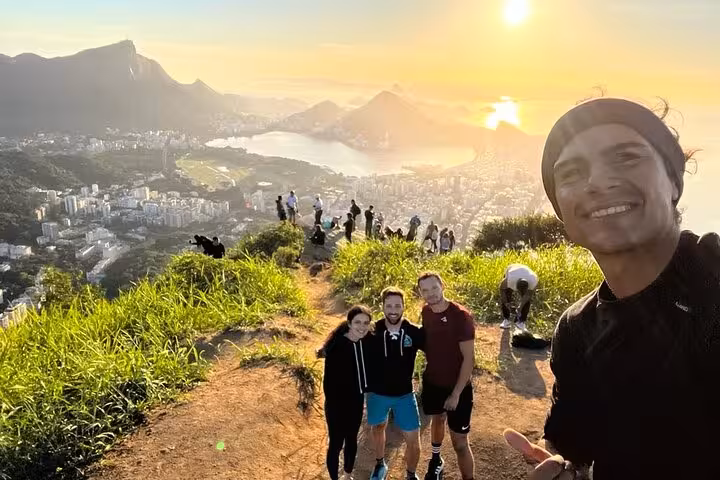 Group of friends capturing a memorable sunrise at Two Brothers mountain with panoramic views of Rio de Janeiro.