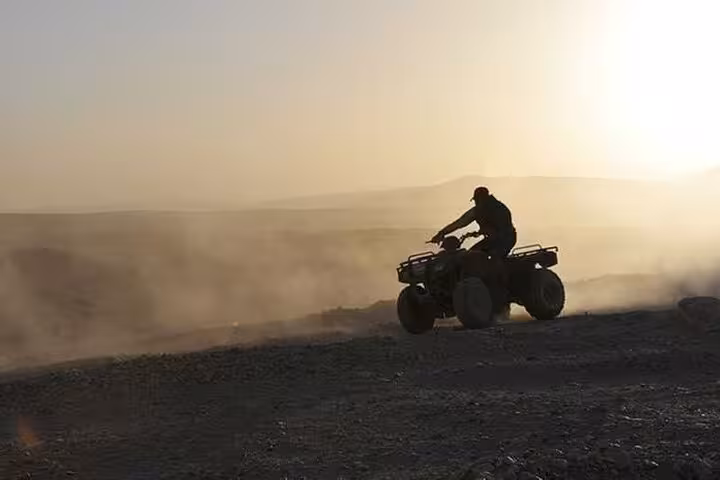 Sunset ATV quad ride in Hurghada desert, kicking up dust on a 3-hour quad safari adventure tour
