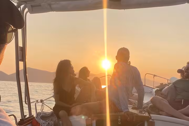 Group enjoying a serene sunset boat tour near La Spezia, highlighting the beauty of Portovenere and Lerici waters.