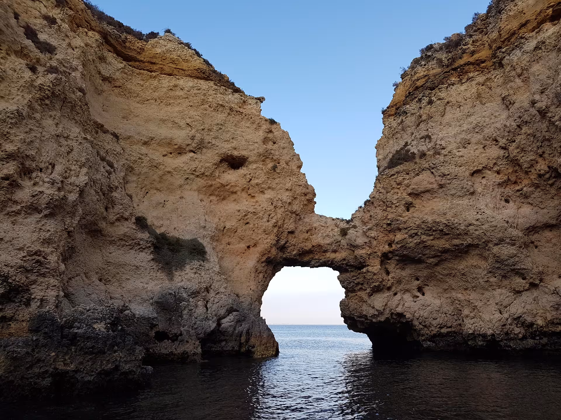 Golden cliffs of Ponta da Piedade glowing at sunset above calm Atlantic waters on a scenic Lagos boat tour in Algarve