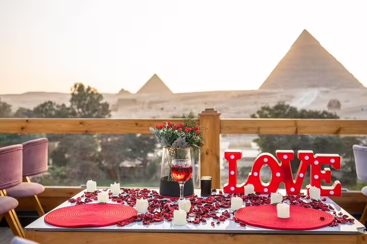 Great Pyramid Inn rooftop dinner with pyramid view at sunset, romantic table before camel ride and show