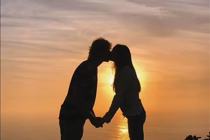 Couple sharing a romantic sunset moment on Algarve Natural Park's West Coast secret off-road tour.