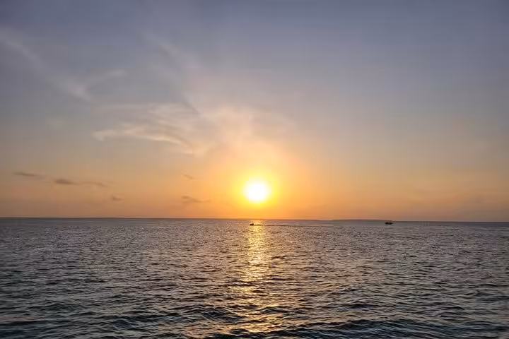 Stunning sunset over the Indian Ocean in Zanzibar, casting golden hues during the Nungwi & Kendwa dhow cruise.