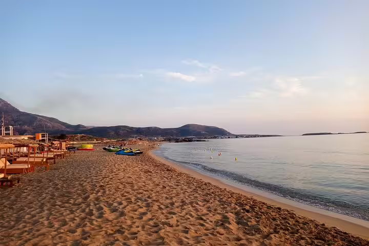 Serene sunset view of the expansive Falasarna Beach coastline with gentle waves in Crete, ideal for private tours.