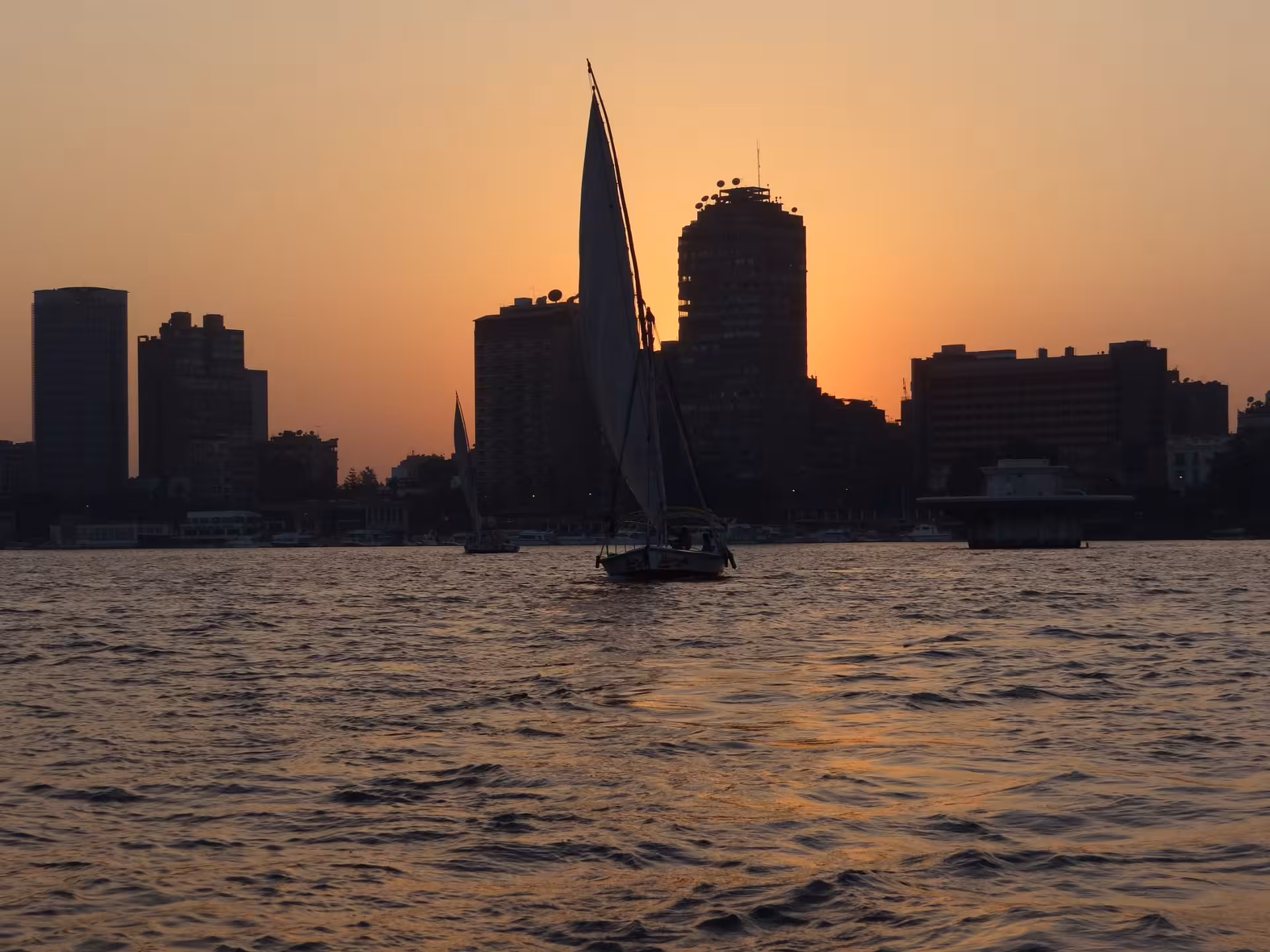 Sunset felucca sailing on the Nile in Cairo with skyline views, part of lunch cruise tour with transfers