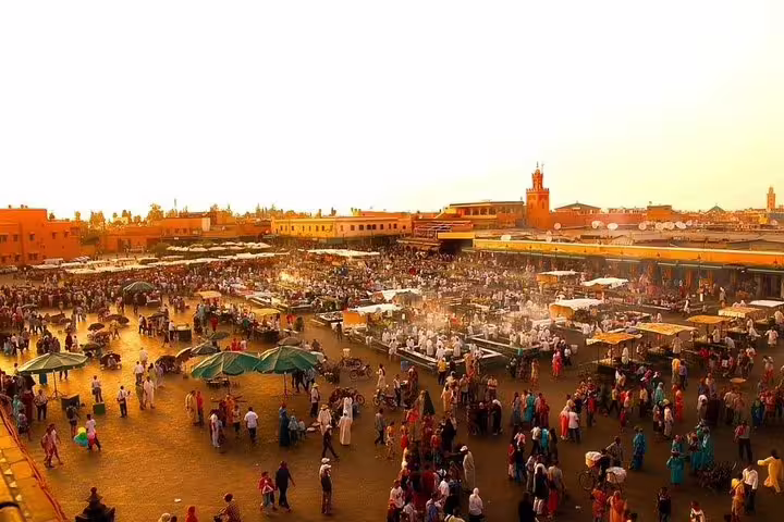 Sunset over Jemaa el-Fnaa square in Marrakech, lively market crowds on an 8 day desert tour from Marrakech