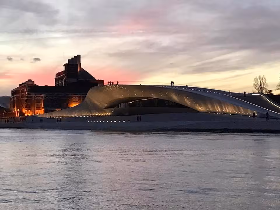 Sunset view of MAAT Lisbon by the Tagus River, scenic highlight on a cultural sail tour in Lisbon