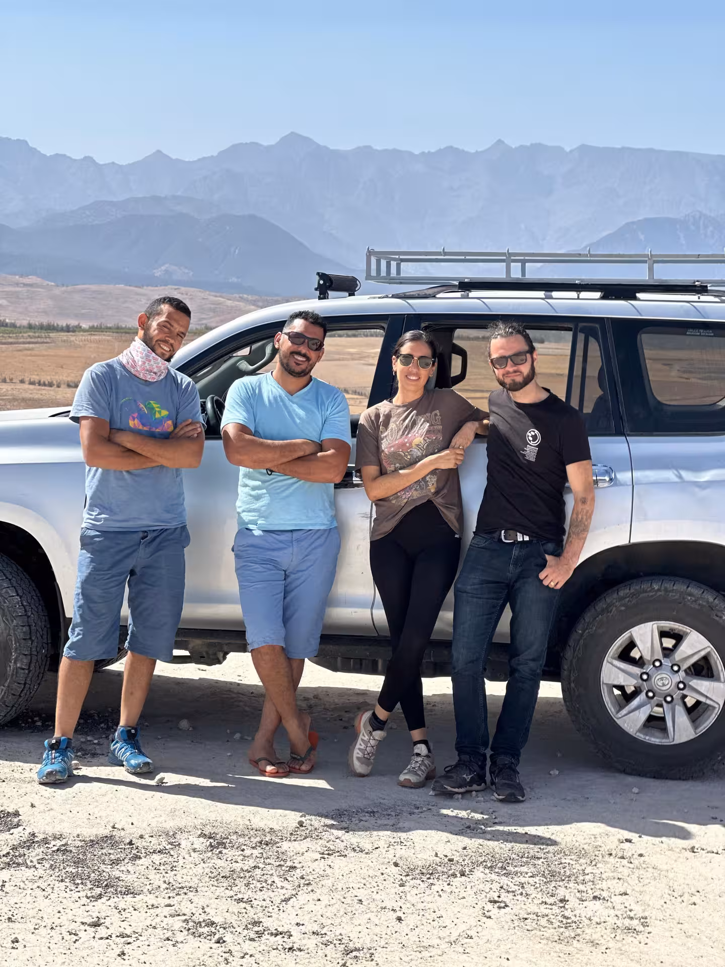 Two excited paragliders preparing for a tandem flight over the Agafay Desert near Marrakech.