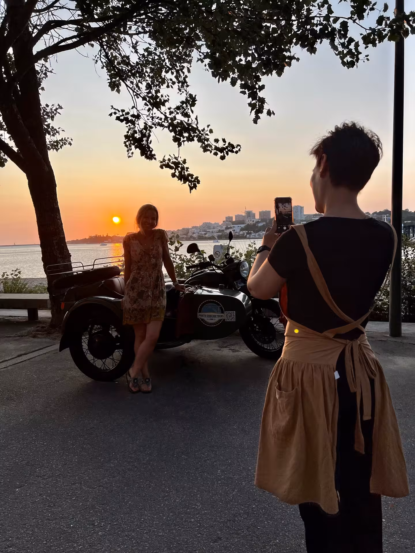 Sunset photo stop on Porto sidecar tour by the Douro River, golden skyline and classic motorcycle
